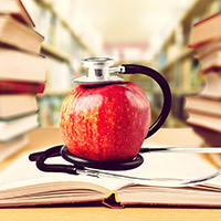 Apple and stethoscope in library of books