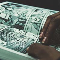 Close up of hands on a an open comic book