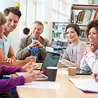 Diverse adults gathered around table